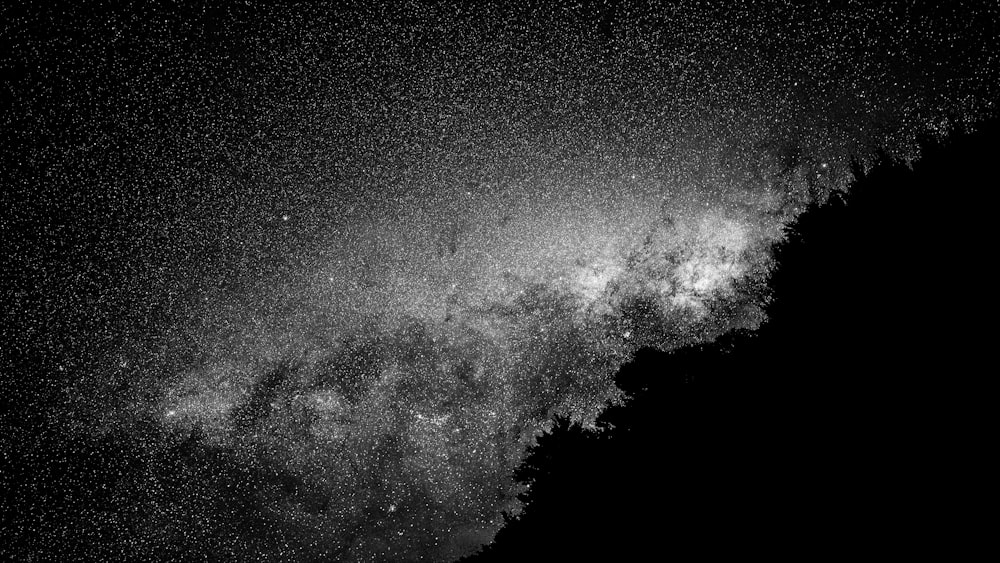 a black and white photo of the night sky