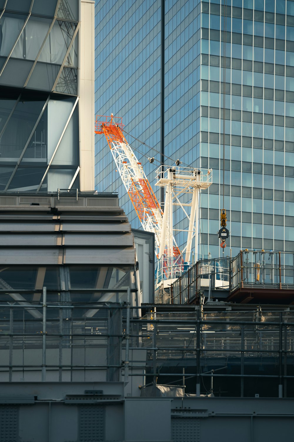 a crane is standing in front of a tall building