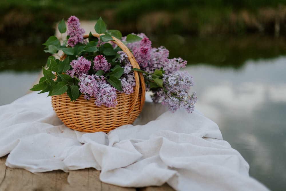 a wicker basket filled with purple flowers