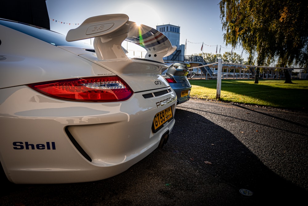 a white sports car parked on the side of the road