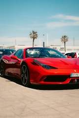 a red sports car parked in a parking lot