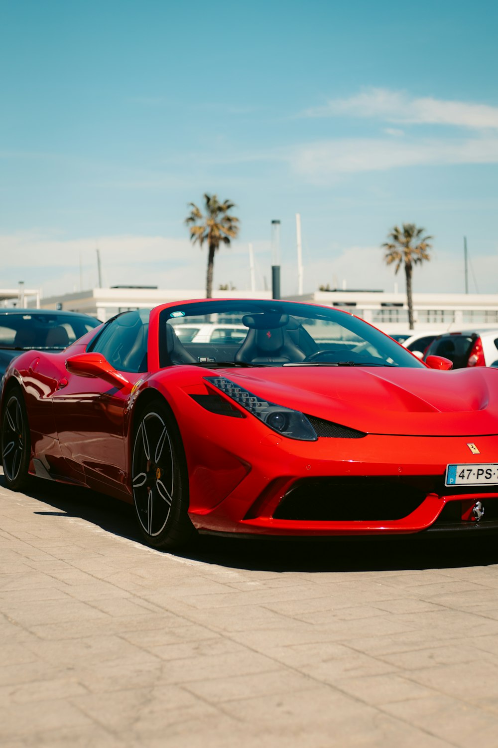 a red sports car parked in a parking lot