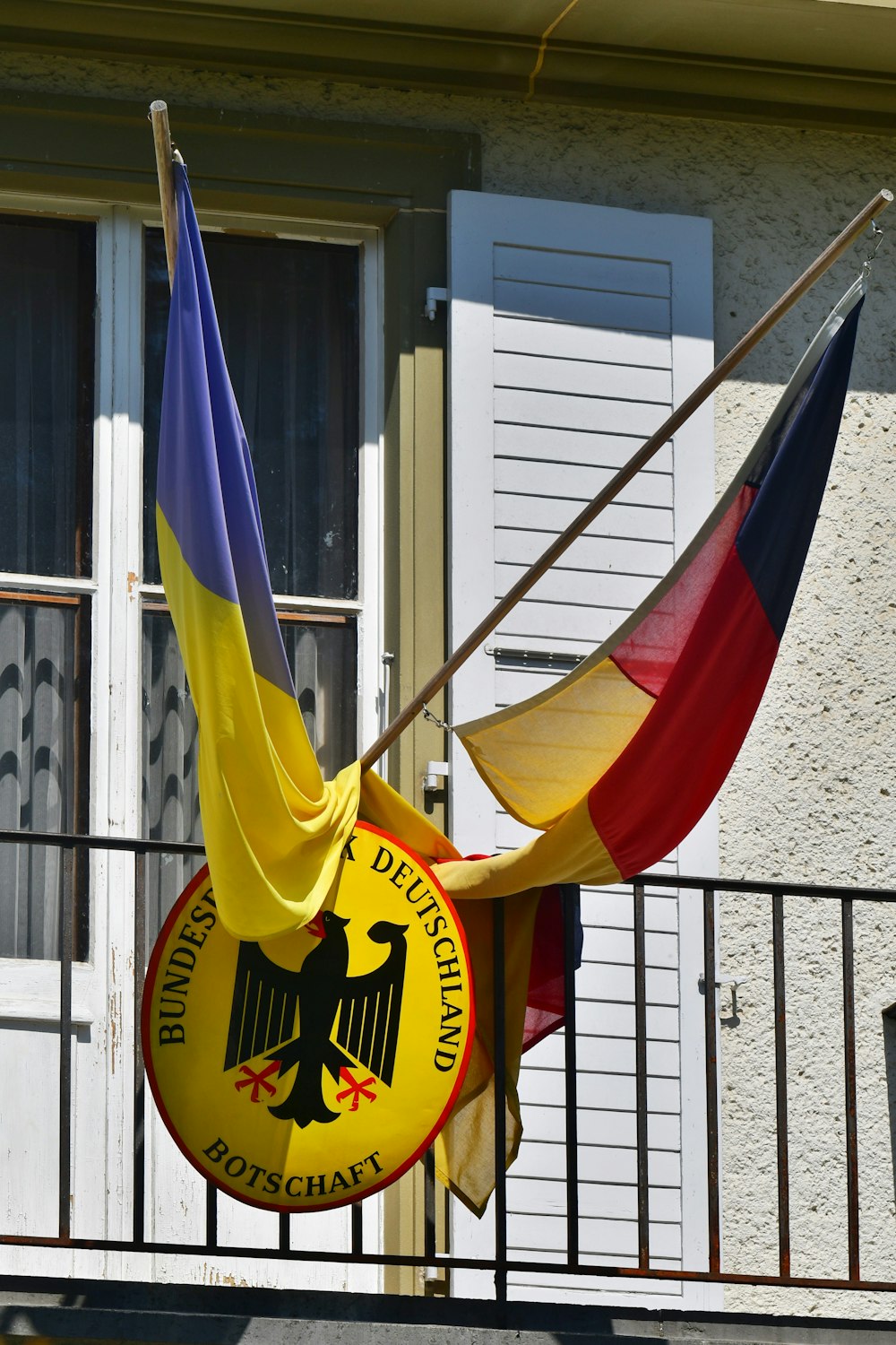 a german flag hanging from the side of a building