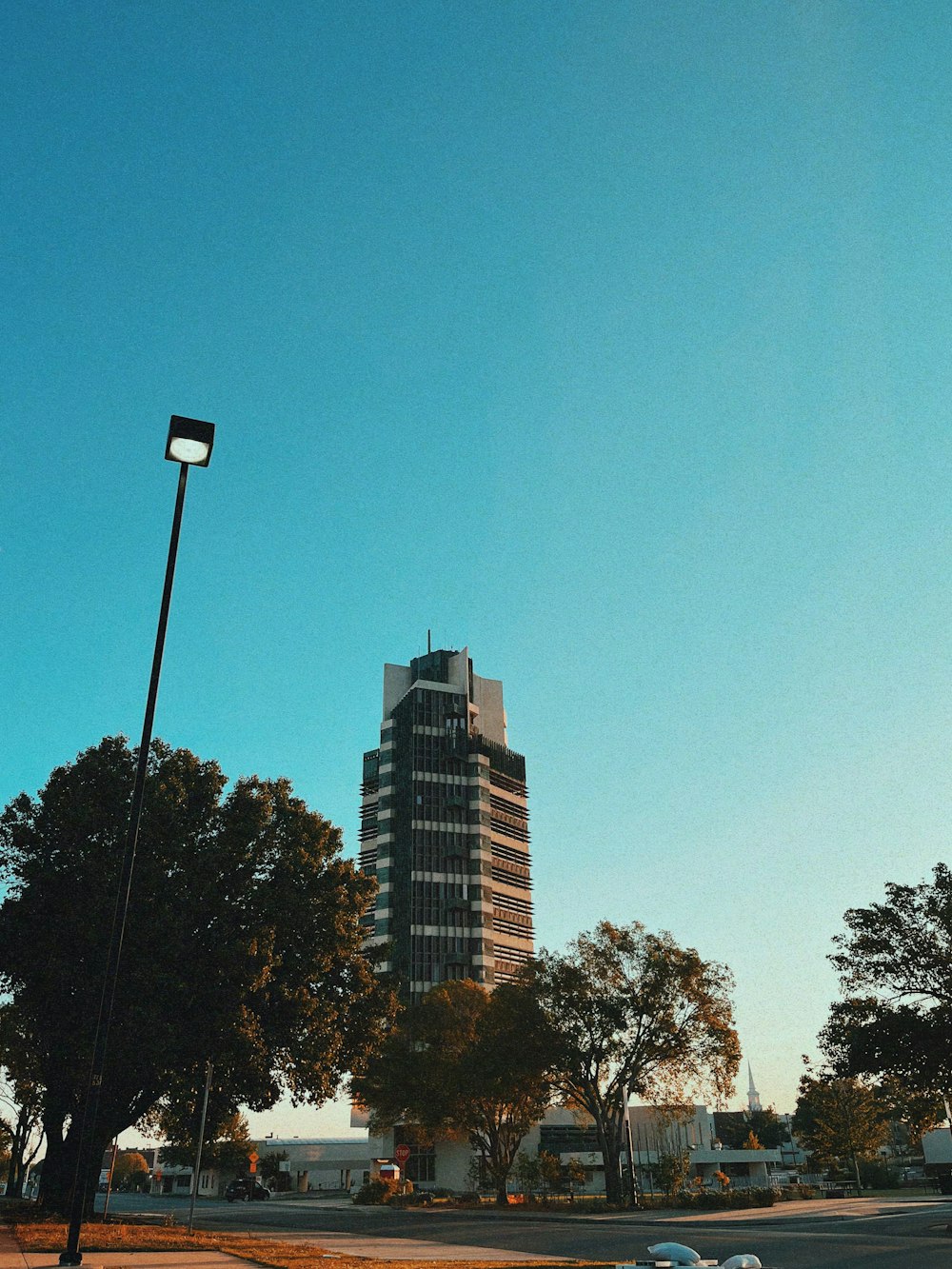 a city street with a tall building in the background