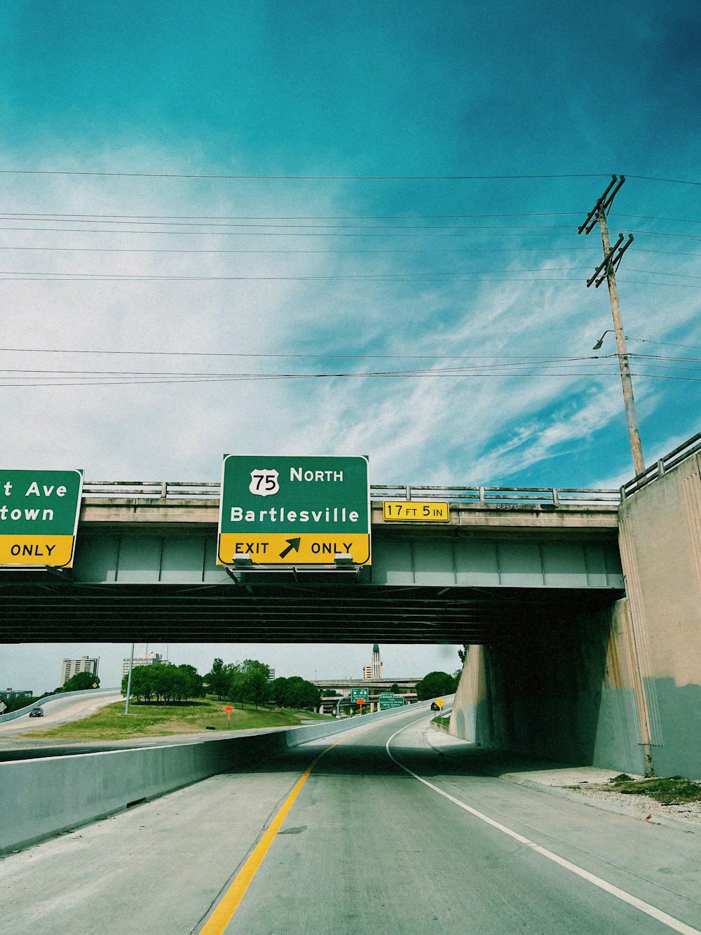 a highway with two freeway signs above it