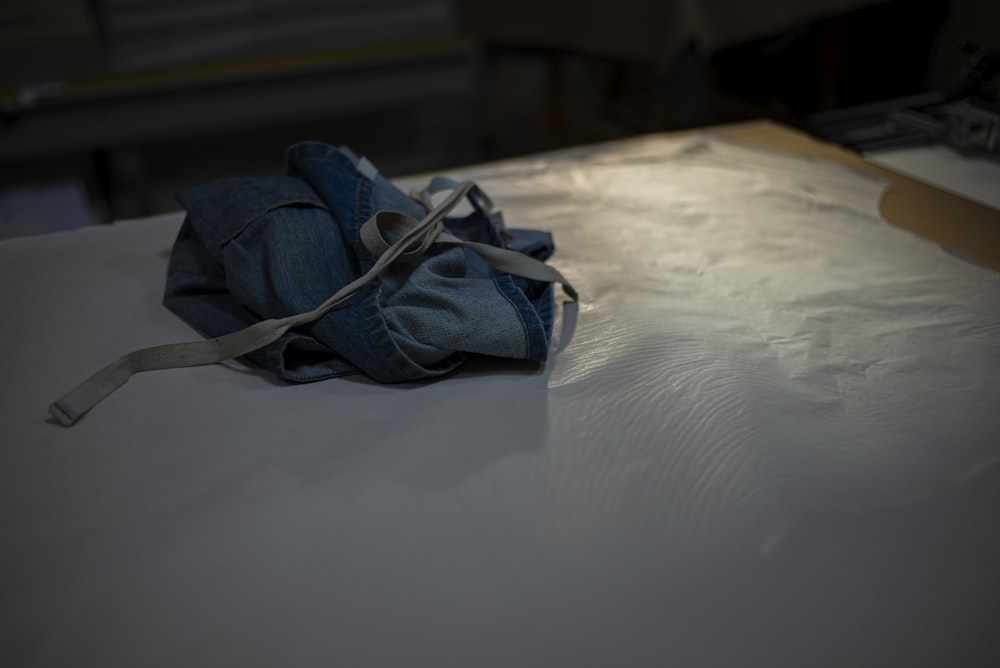a pair of jeans are laying on a bed