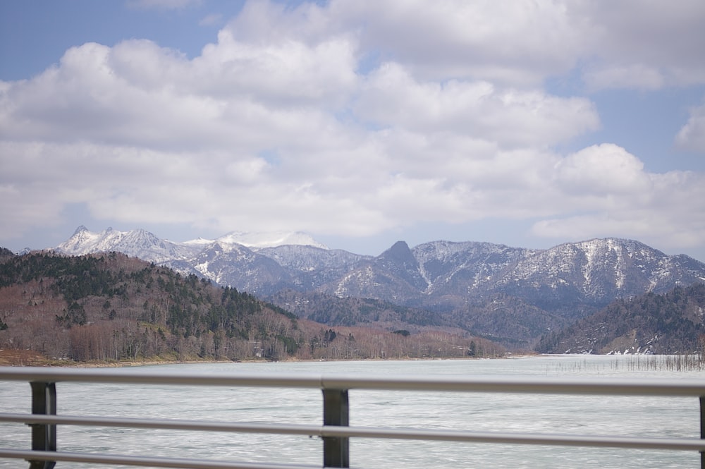 a view of a mountain range with a lake in the foreground