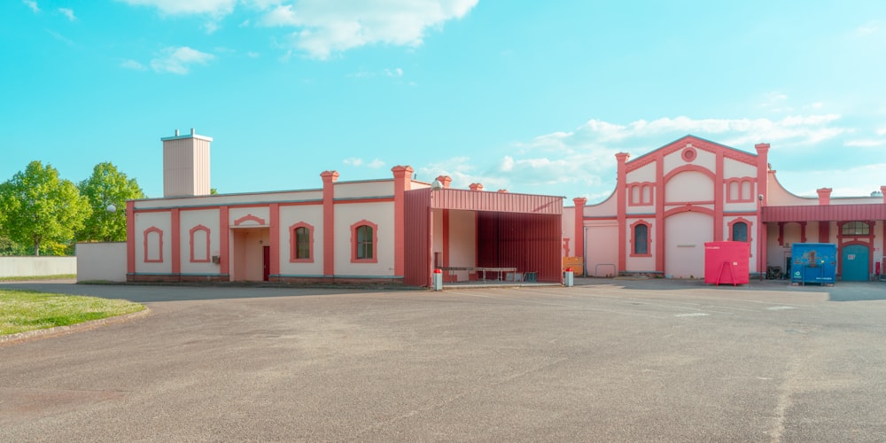 a pink and white building with a red door