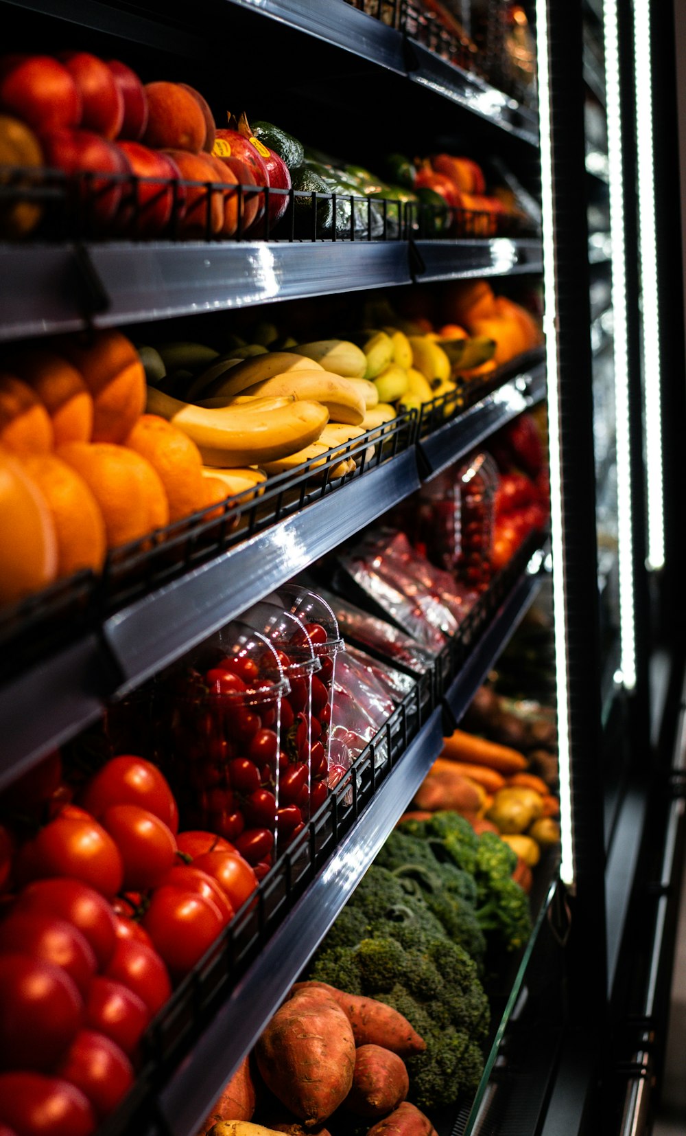 a display in a grocery store filled with lots of fruits and vegetables