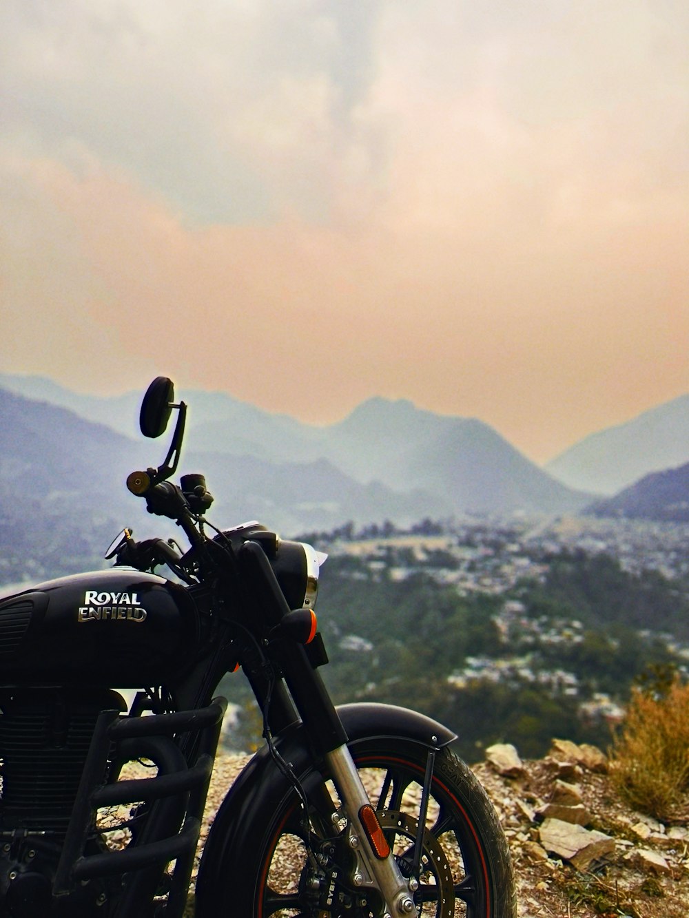 a motorcycle is parked on a rocky hill