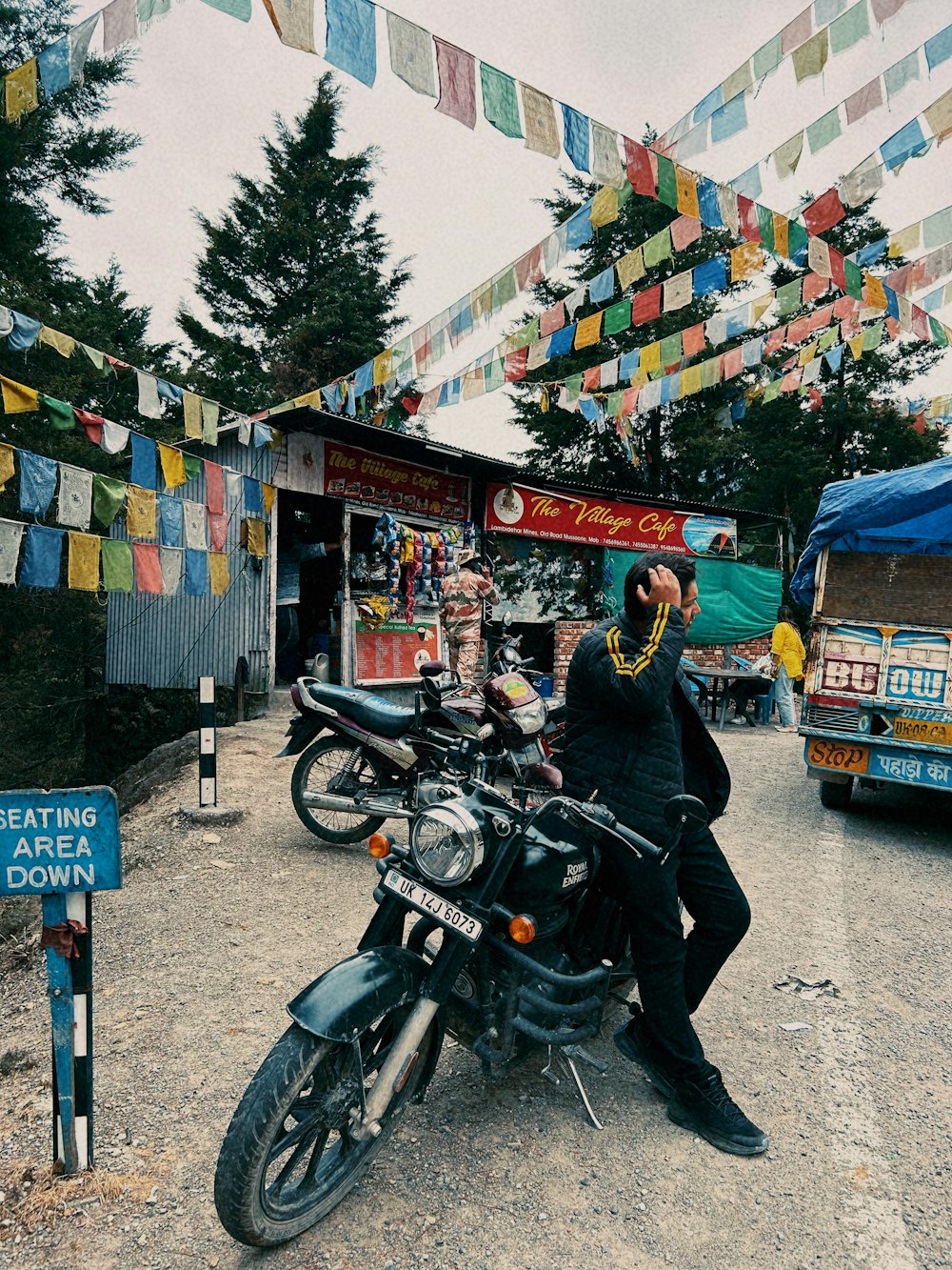 a man sitting on a motorcycle in front of a store