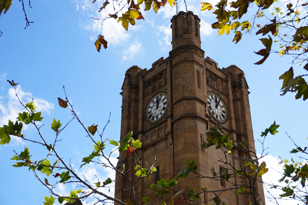 a tall clock tower with a clock on each of it's sides