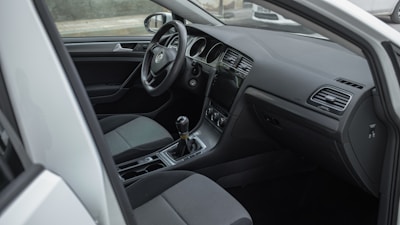 the interior of a car with a steering wheel and dashboard