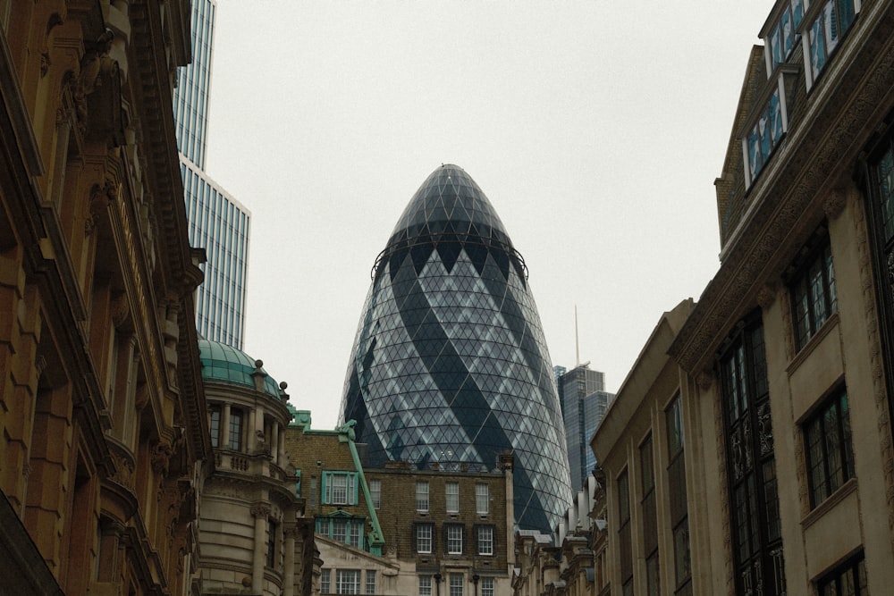 a very tall glass building towering over a city