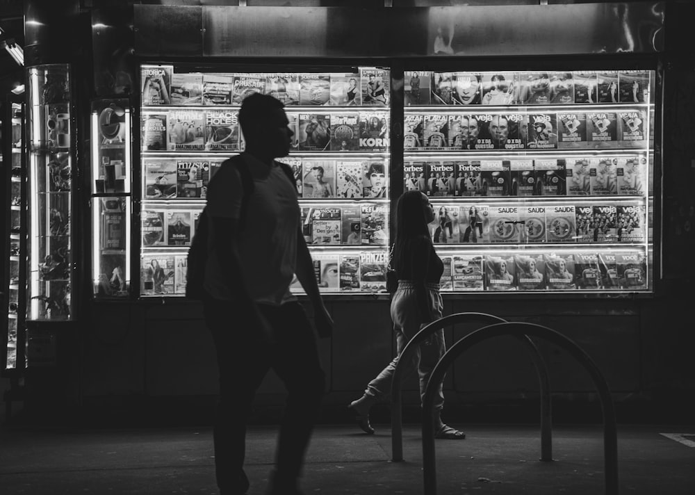 a man and a woman standing in front of a store