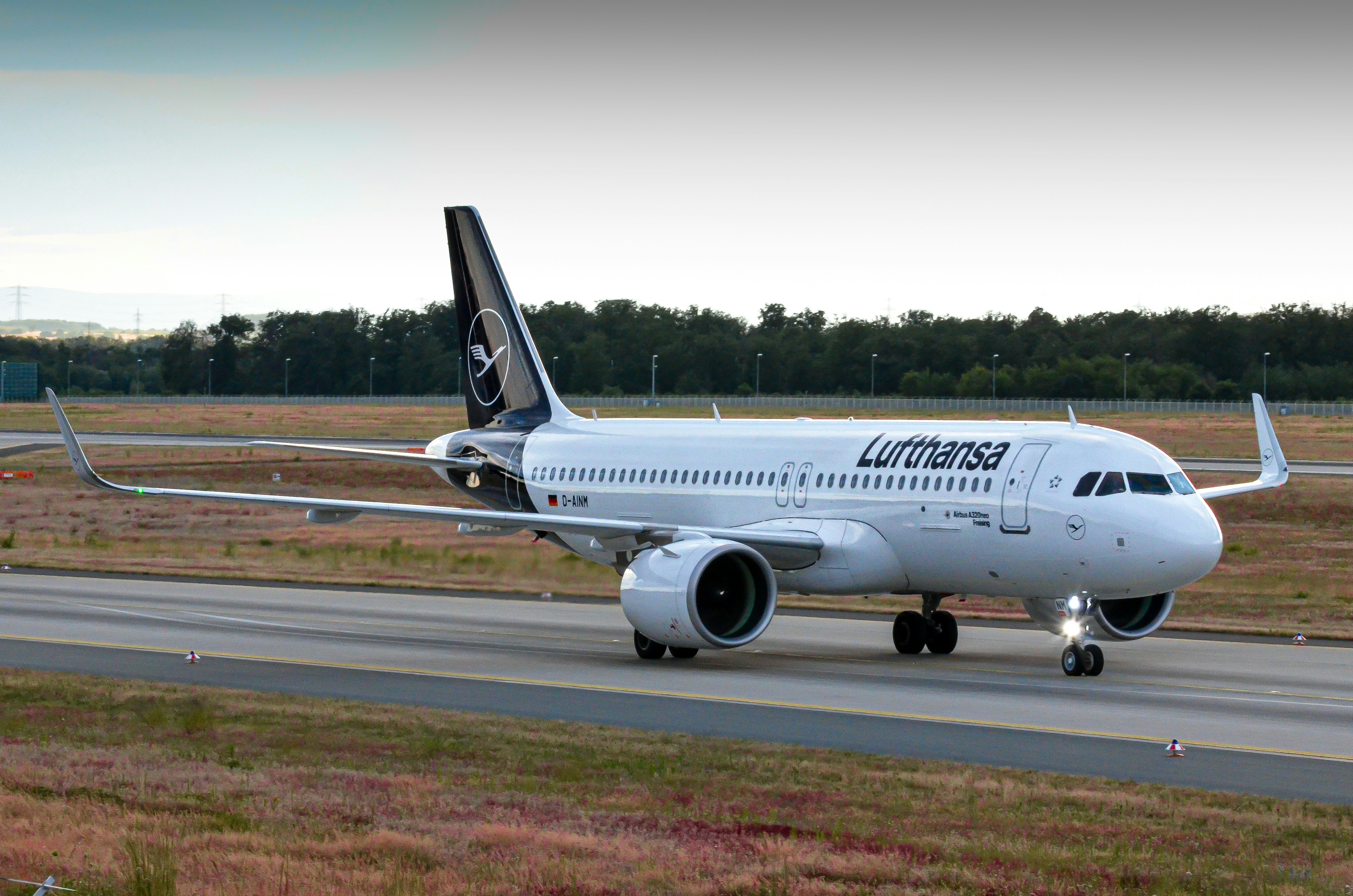 a large jetliner sitting on top of an airport runway, 