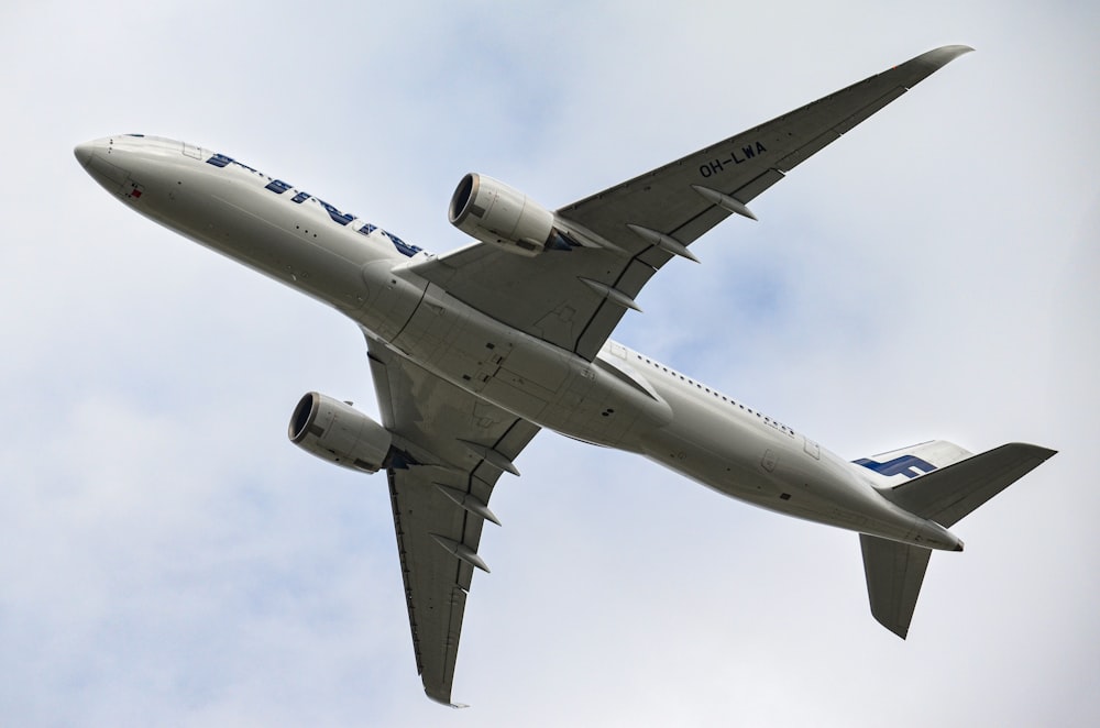 a large jetliner flying through a cloudy blue sky