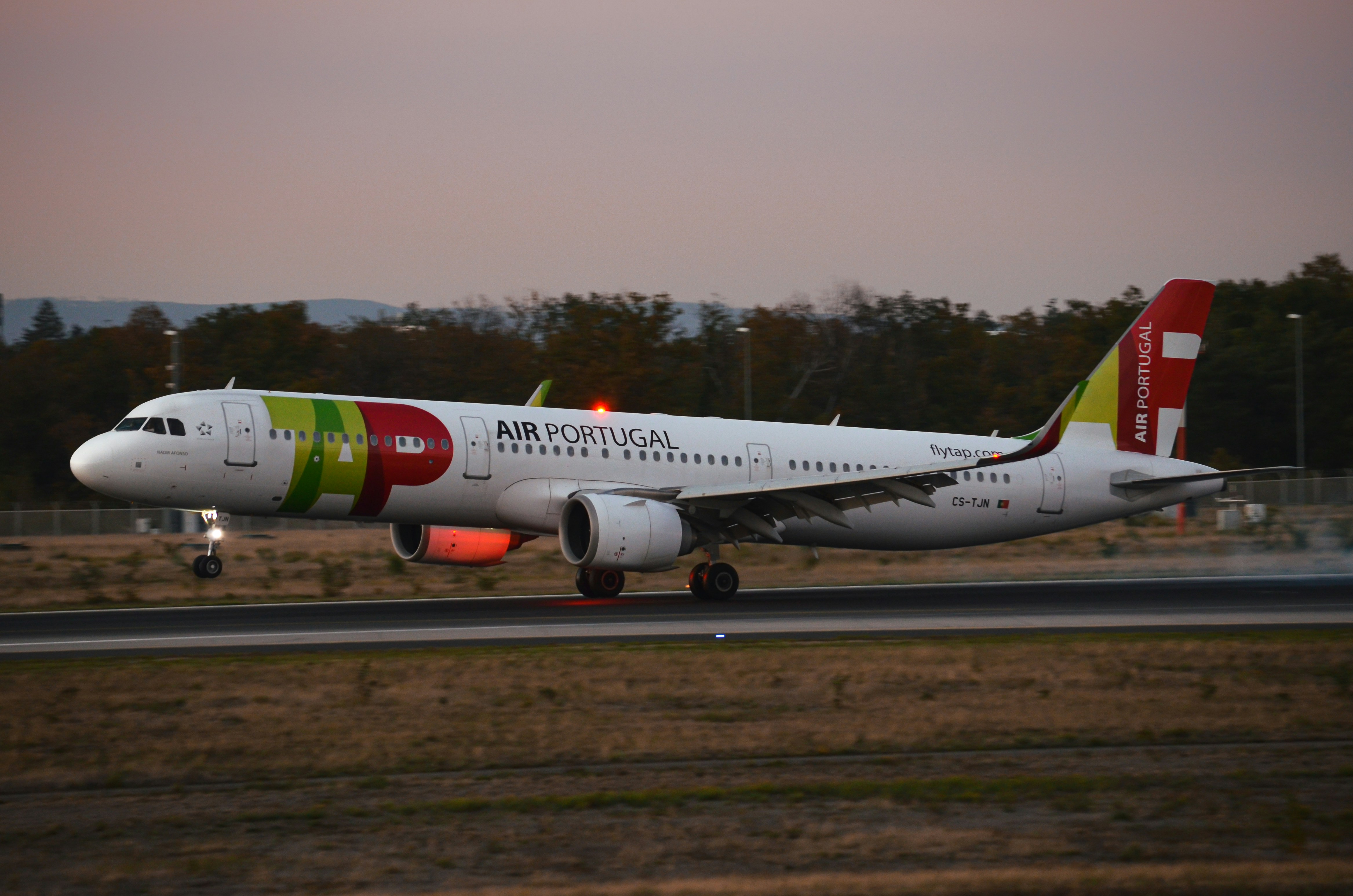 a large passenger jet taking off from an airport runway, 