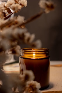 a lit candle sitting on top of a table