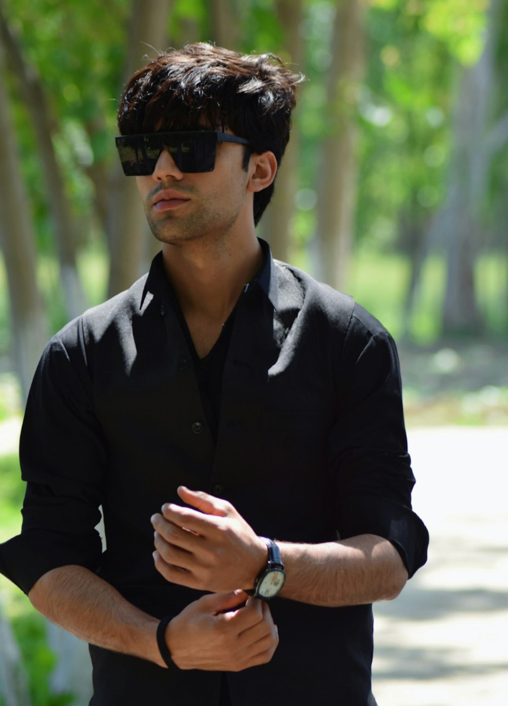 a man wearing a black shirt and sunglasses