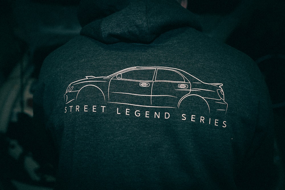 a man wearing a hoodie with a picture of a car on it