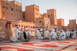 a group of people standing on top of a rug