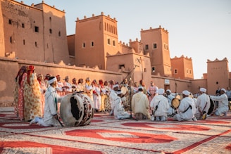 a group of people standing on top of a rug