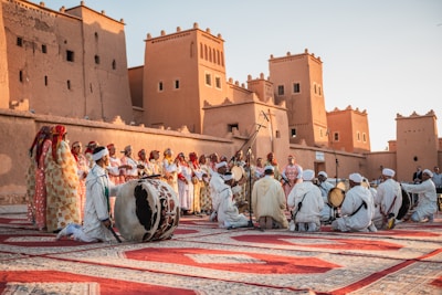 a group of people standing on top of a rug