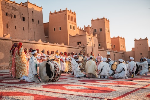 a group of people standing on top of a rug