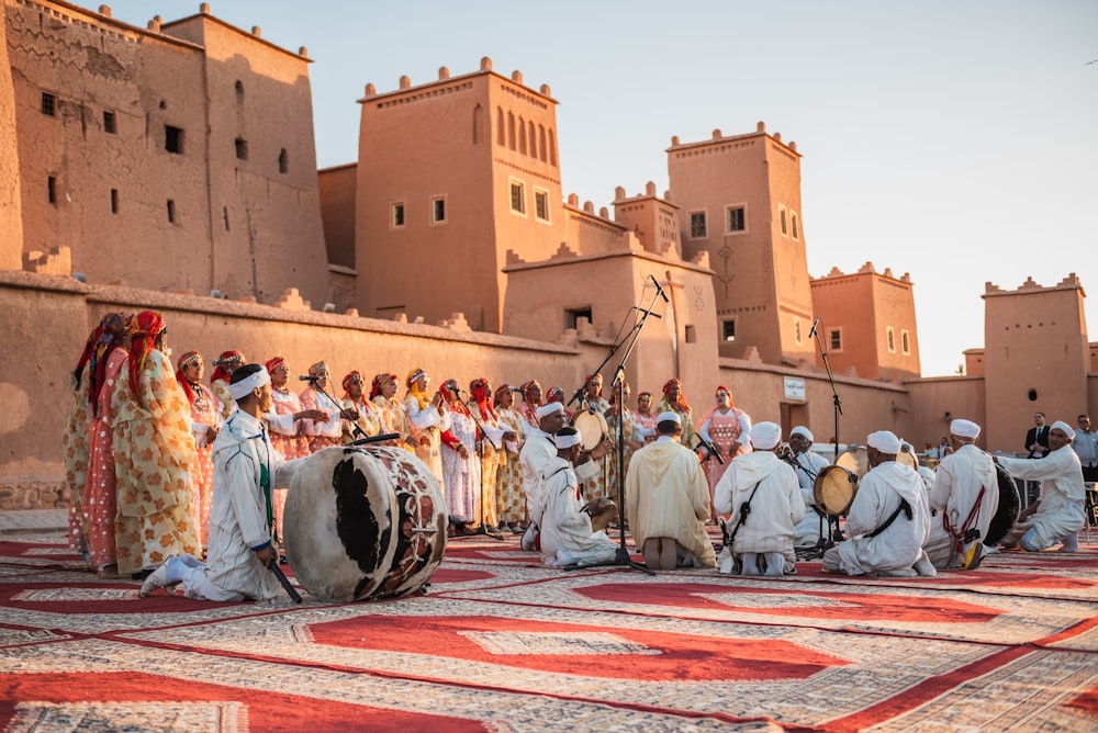 a group of people standing on top of a rug