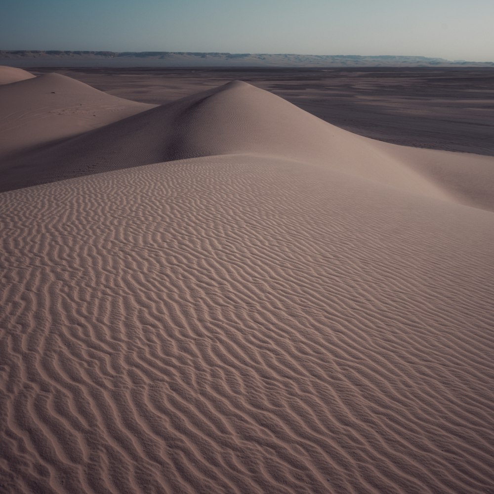 a large expanse of sand in the middle of a desert