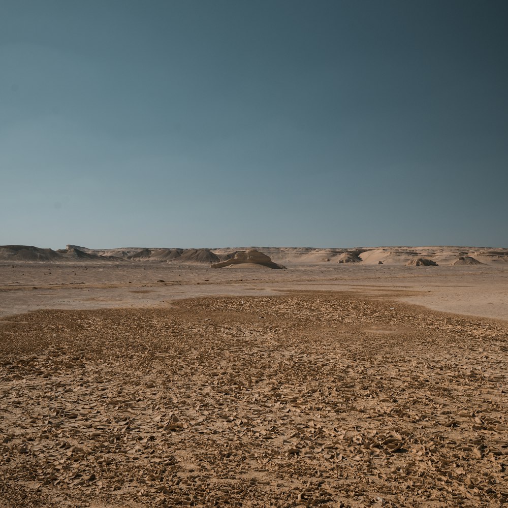 a dirt field in the middle of a desert