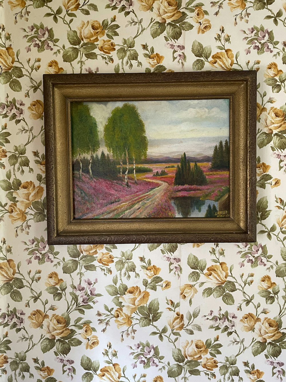 a painting hanging on the wall of a room
