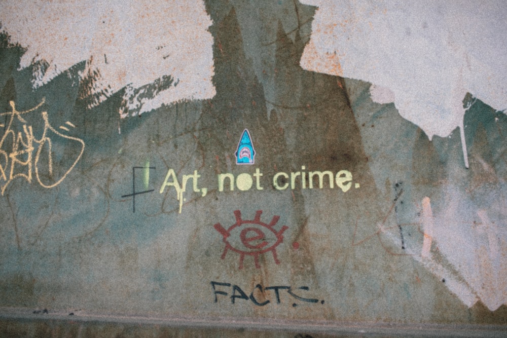 graffiti on the side of a wall that says art, not crime