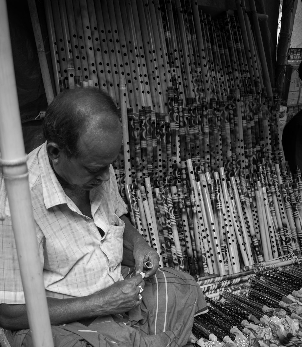 a man sitting on the ground working on something