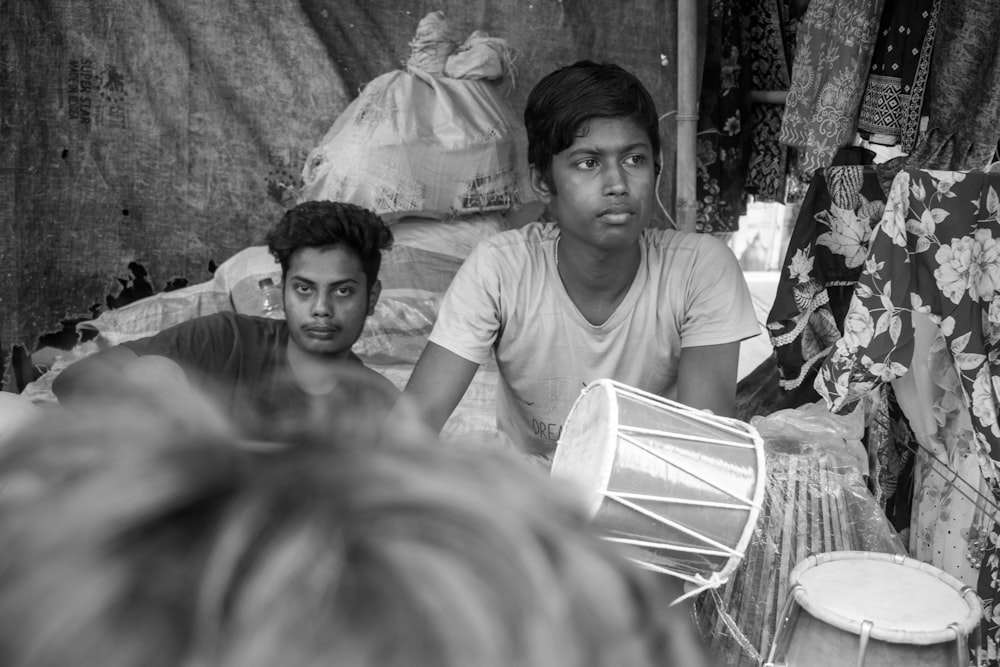 a black and white photo of two men sitting at a table