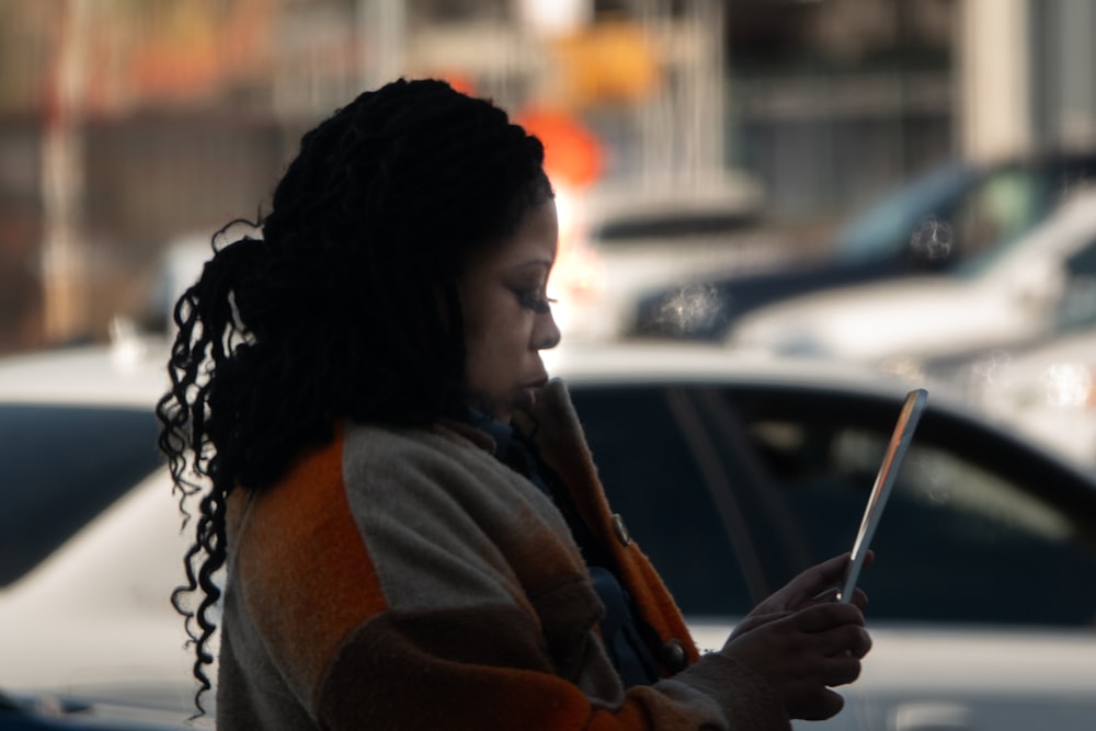 a woman is looking at her cell phone