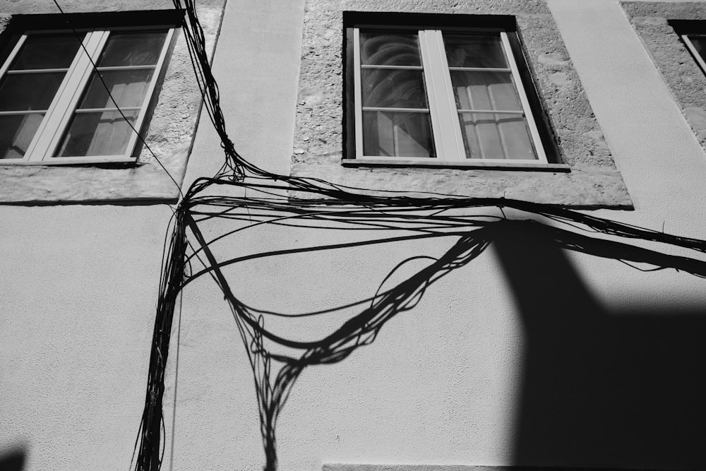 a black and white photo of a building with wires in front of it
