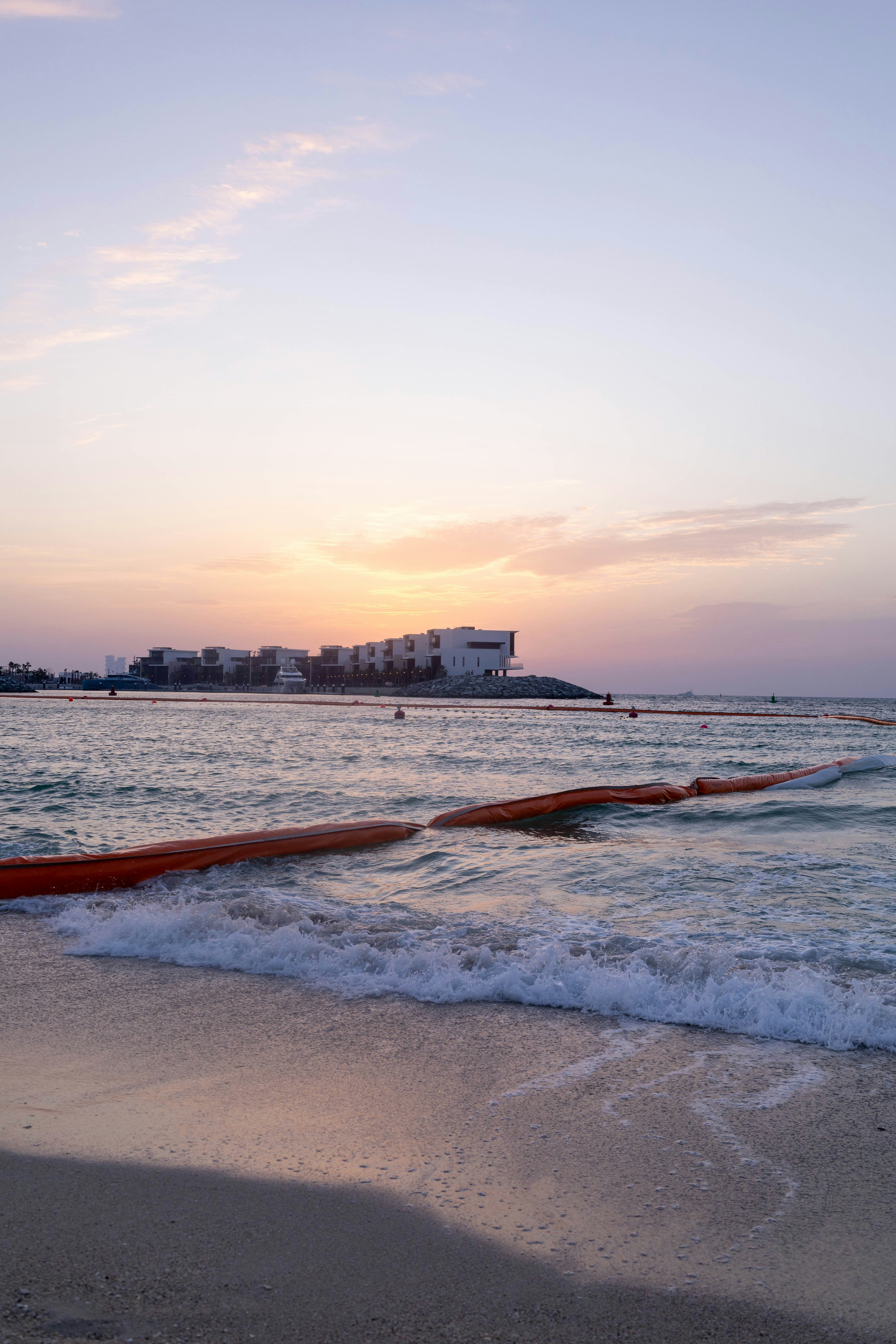a view of a beach with waves coming in to shore