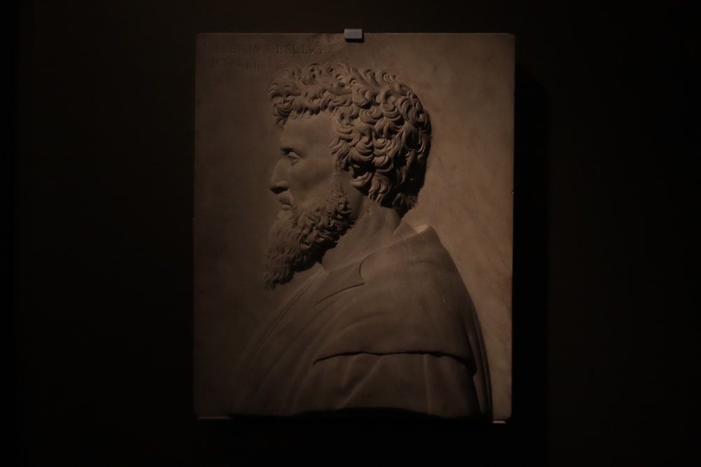 a black and white photo of a bust of a man