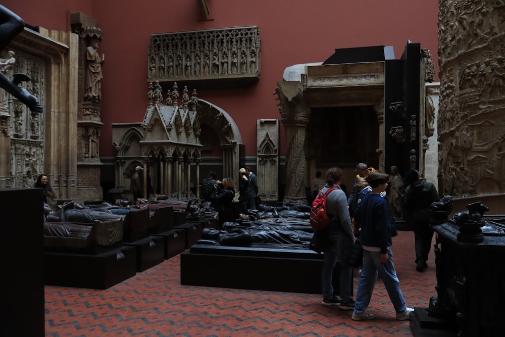 a group of people walking around a museum