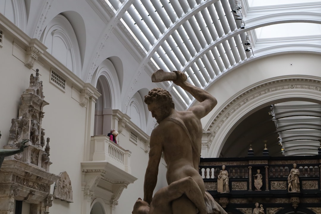 a statue of a man holding a rock in a building,