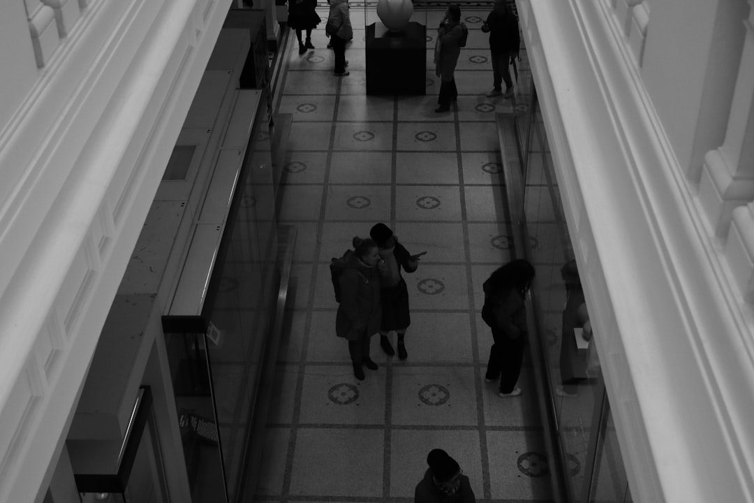 a black and white photo of people in a building,
