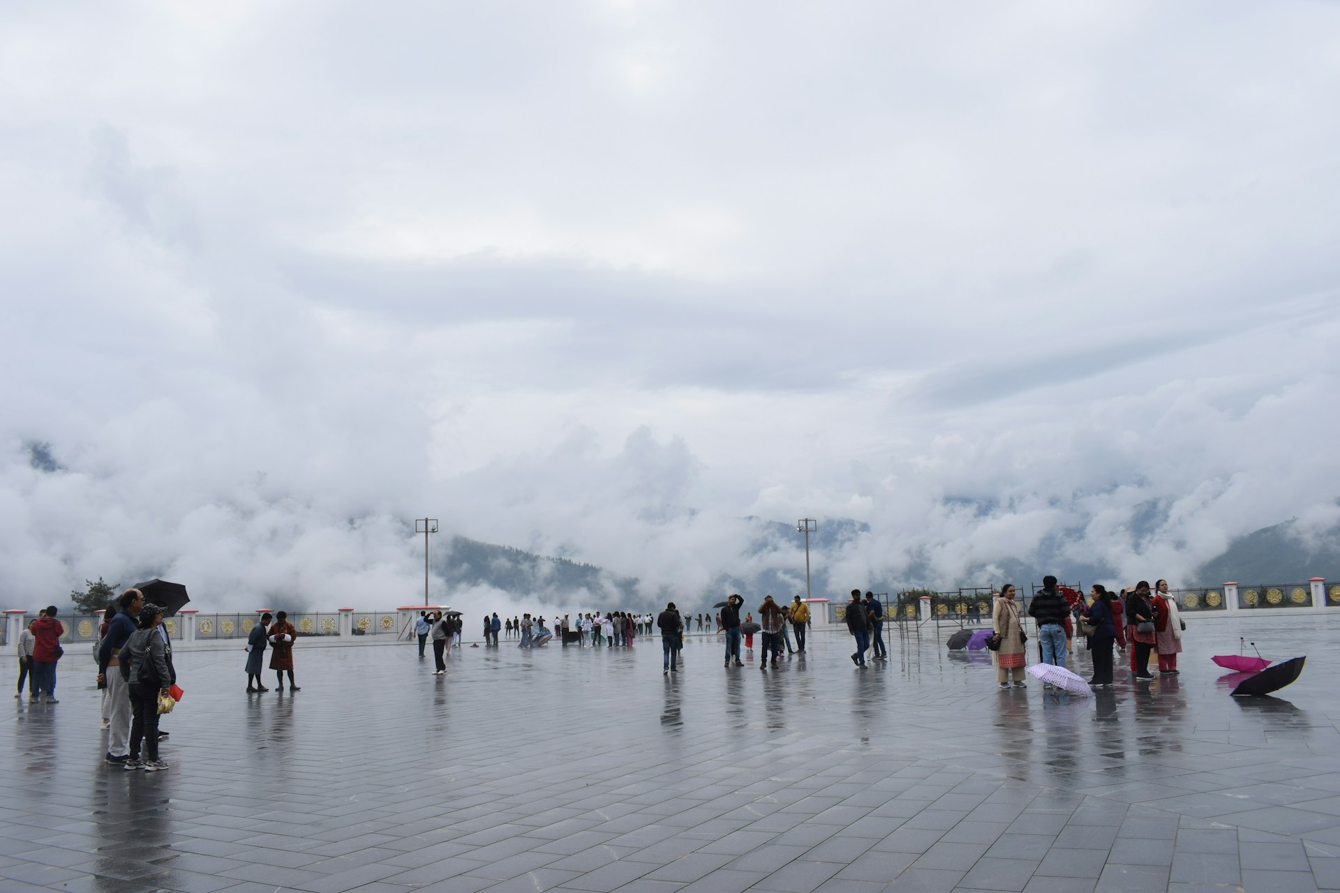 a group of people standing around in the rain