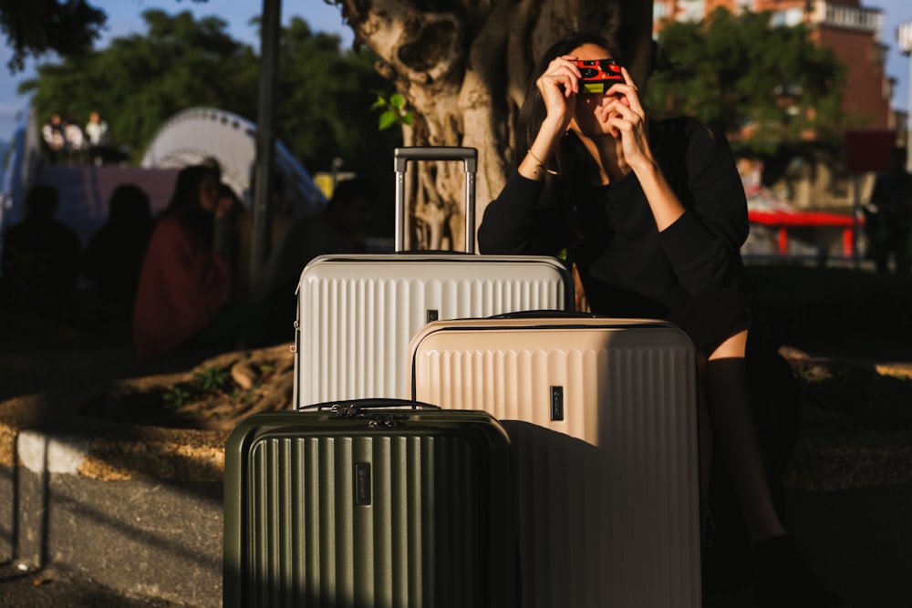 a woman taking a picture of her luggage