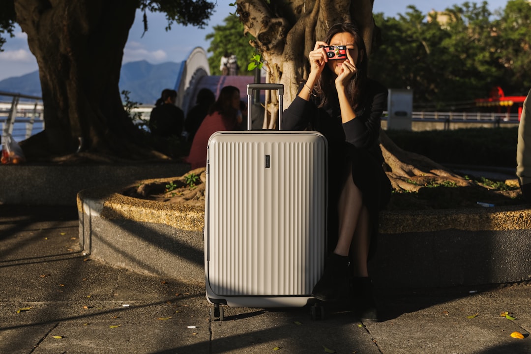 a woman taking a picture of herself with her cell phone, Eminent Luggage