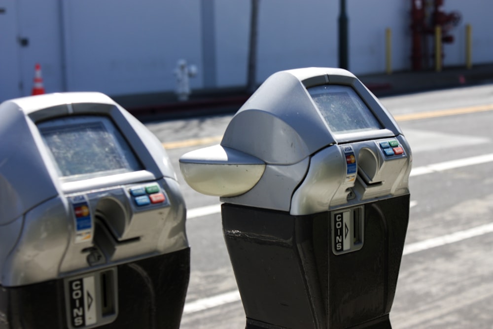 a couple of parking meters sitting on the side of a road