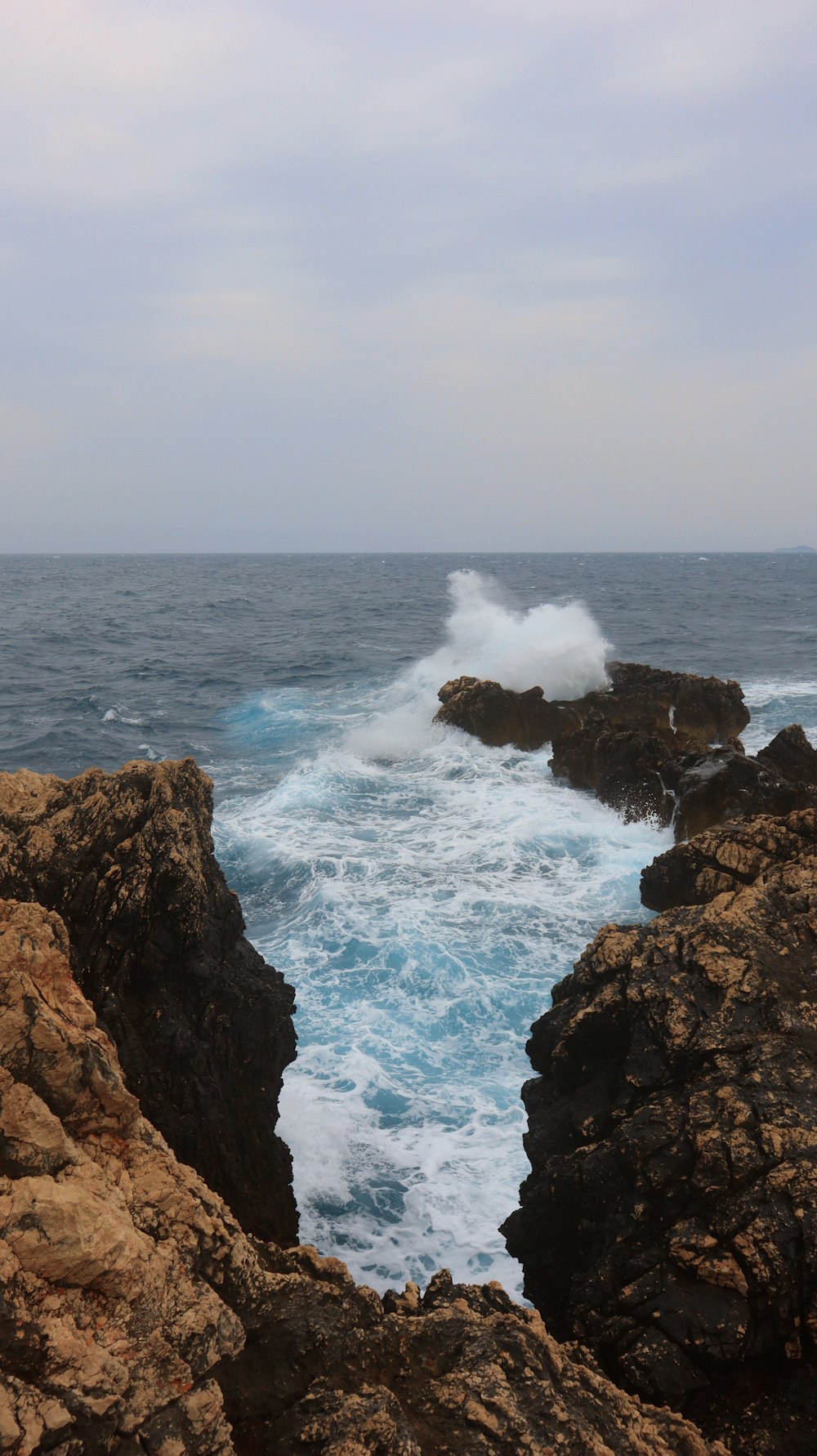 a large body of water near a rocky shore