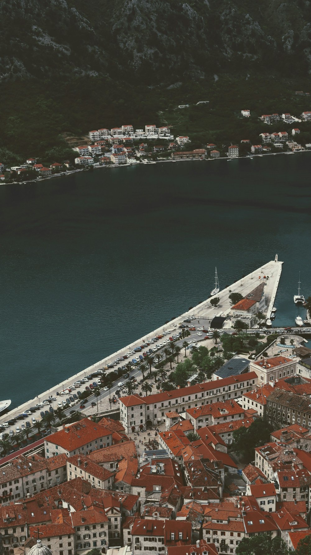 an aerial view of a city next to a body of water