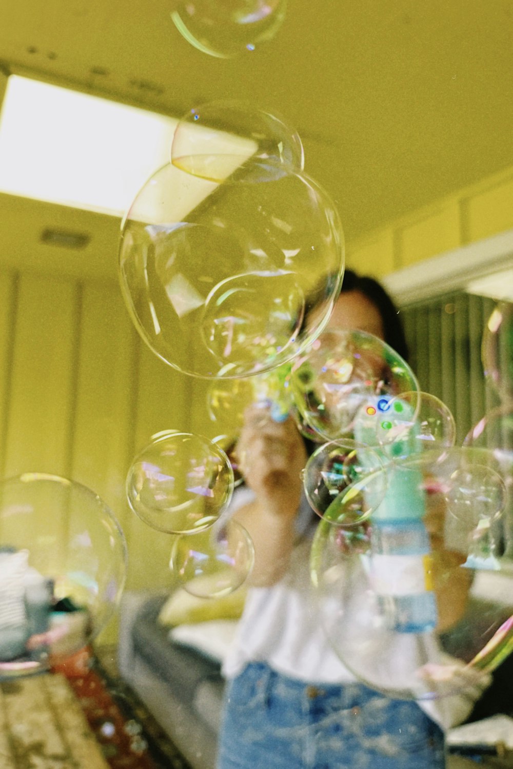 a person blowing bubbles in a room